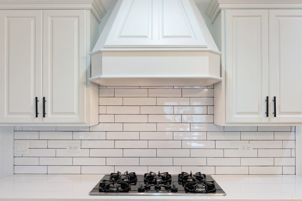 kitchen counter with white tile backsplash
