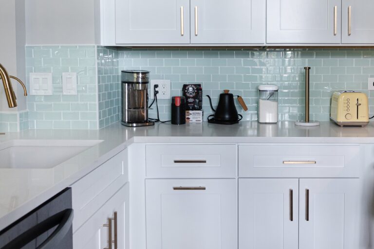 custom design kitchen cabinets with light blue backsplash