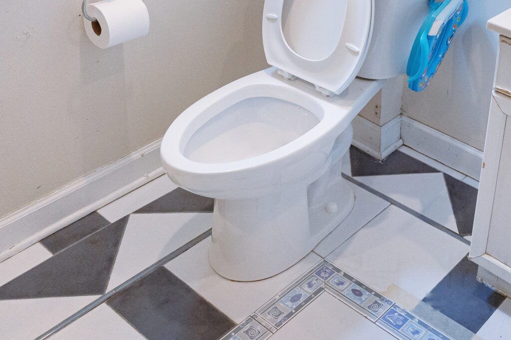 Dated bathroom with a patterned tile floor, photographed before the remodel begins
