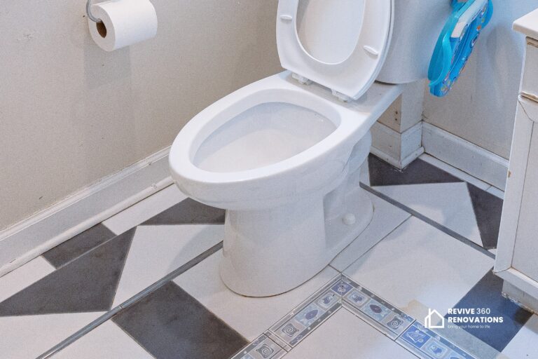 toilet in a bathroom with old tile floor