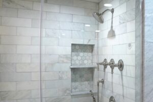 Tiled shower with white tile walls in a Chicago bathroom