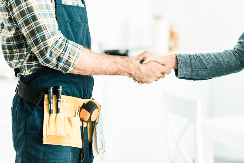 plumber and client shaking hands
