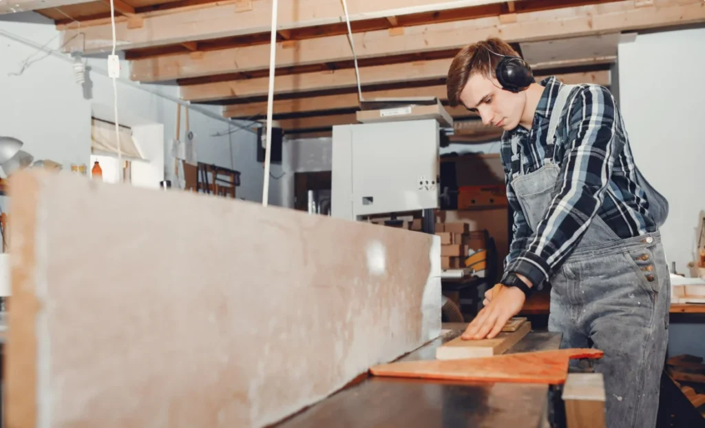 Carpenter cutting wood in a professional workshop